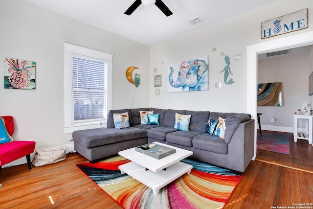 living room with hardwood / wood-style floors and ceiling fan