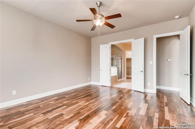 unfurnished bedroom featuring hardwood / wood-style floors and ceiling fan