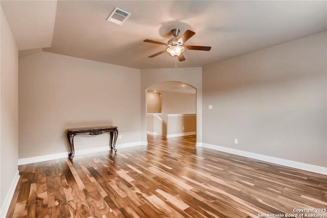 spare room featuring ceiling fan, wood-type flooring, and vaulted ceiling