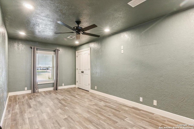 unfurnished room featuring ceiling fan and light wood-type flooring