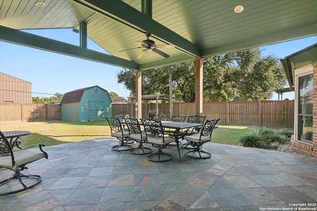 view of patio featuring ceiling fan and a storage shed