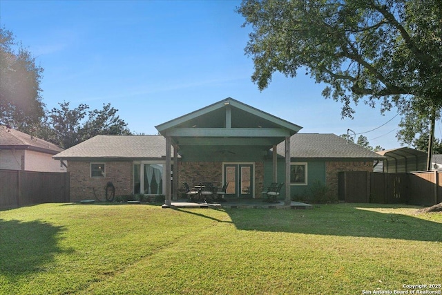 back of property featuring a yard and a carport