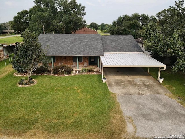 view of front of house with a front yard and a carport