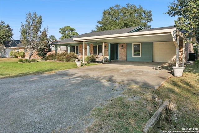 ranch-style home featuring a front yard, a carport, and a garage