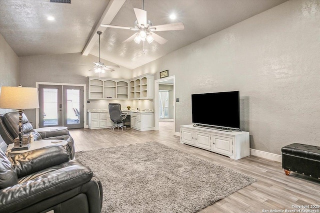 living room with ceiling fan, light hardwood / wood-style flooring, lofted ceiling with beams, and french doors