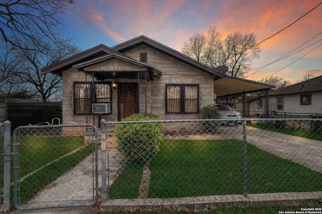 bungalow-style home featuring a carport and a yard