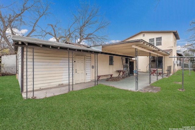 rear view of house featuring a patio area and a lawn