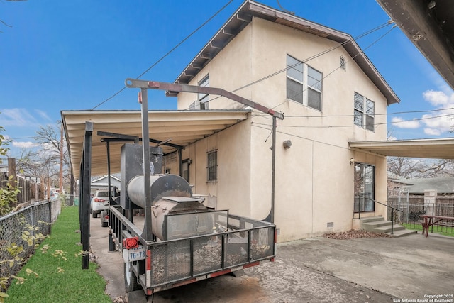 back of house with a carport