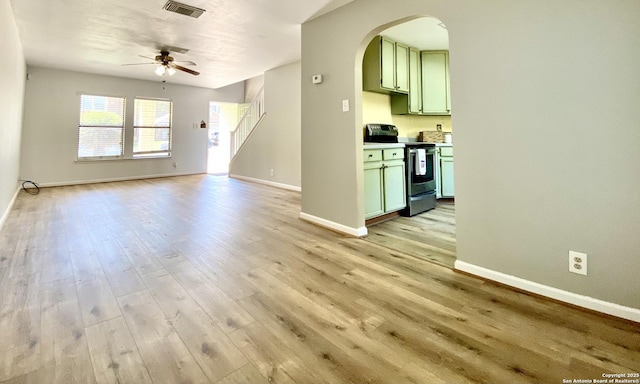 unfurnished living room with light hardwood / wood-style floors and ceiling fan