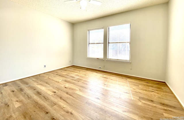 unfurnished room with light wood-type flooring, a textured ceiling, and ceiling fan