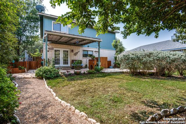 rear view of house with french doors, a lawn, and a patio area