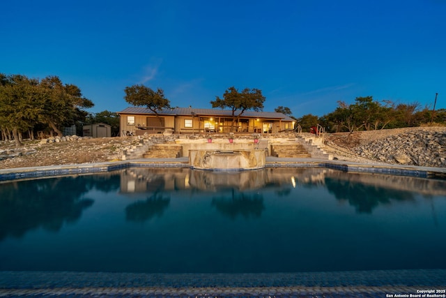 view of swimming pool with a storage unit