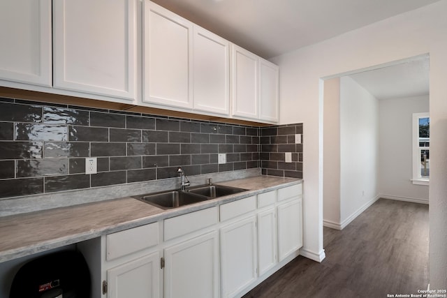 kitchen featuring sink, white cabinets, tasteful backsplash, and dark hardwood / wood-style flooring