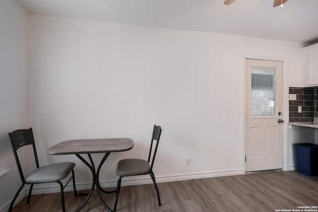 dining area featuring wood-type flooring and ceiling fan