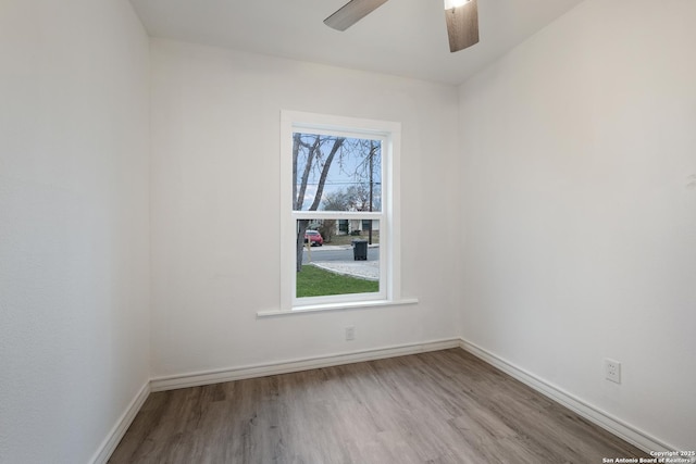 spare room featuring hardwood / wood-style floors, plenty of natural light, and ceiling fan