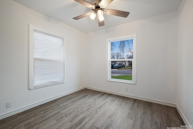 unfurnished room with ceiling fan and hardwood / wood-style floors