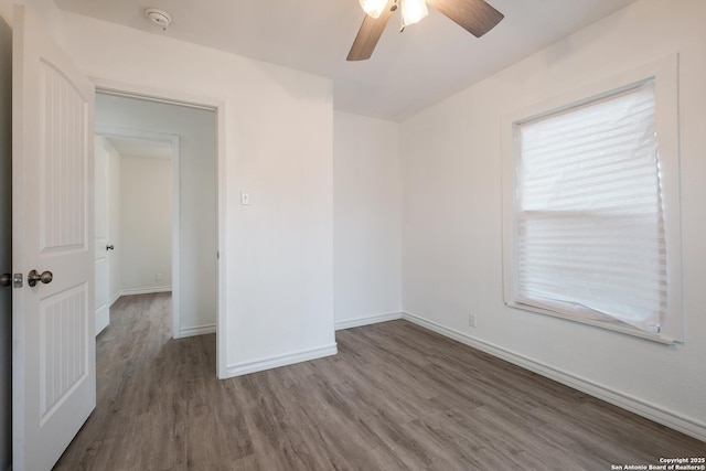 unfurnished room with wood-type flooring and ceiling fan