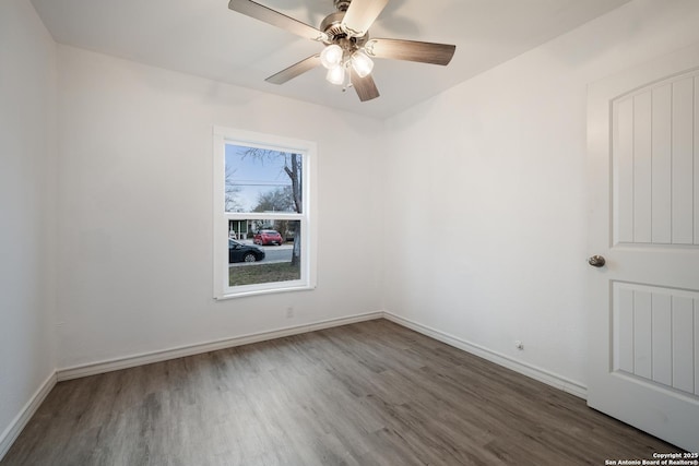 unfurnished room featuring ceiling fan and dark wood-type flooring