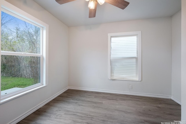 empty room with hardwood / wood-style flooring, ceiling fan, and plenty of natural light