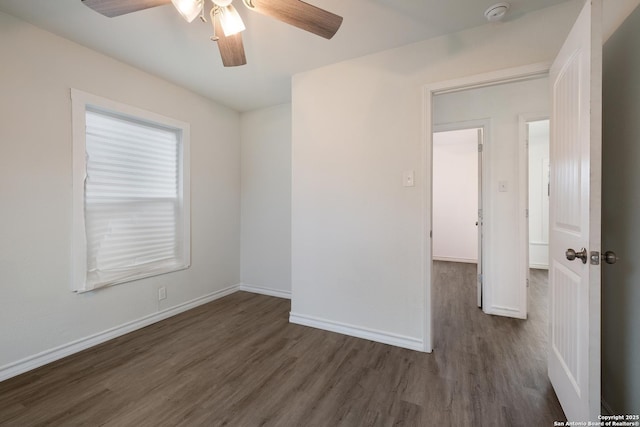 spare room featuring ceiling fan and dark wood-type flooring