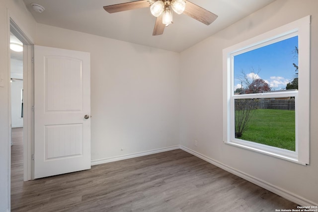 unfurnished room featuring hardwood / wood-style floors and ceiling fan