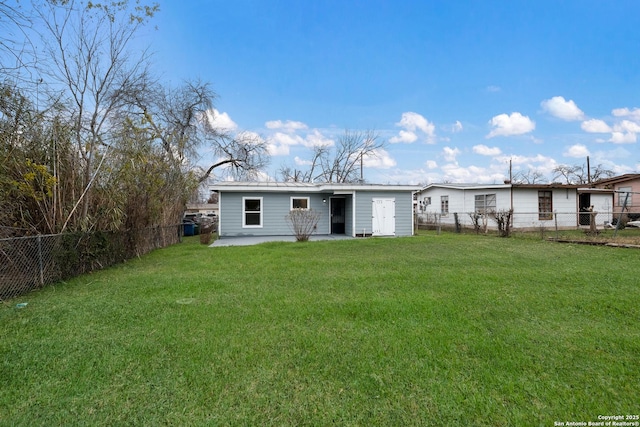 back of property featuring a patio area and a lawn