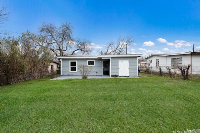 back of house featuring a yard and a patio