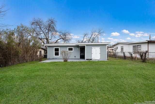 back of house featuring a yard and a patio