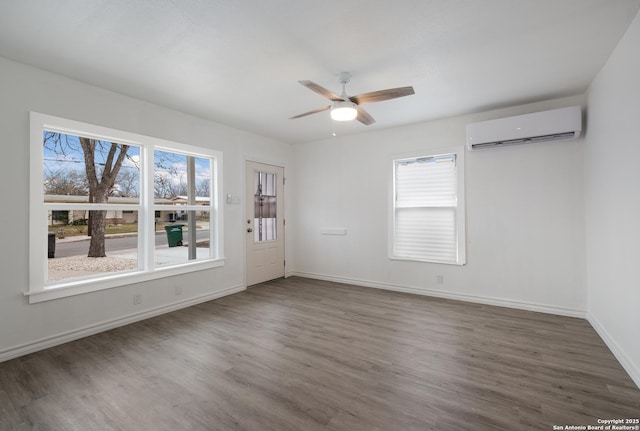 unfurnished room featuring dark wood-type flooring, a wall mounted AC, and ceiling fan