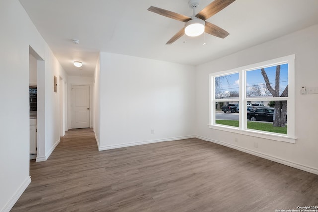 empty room featuring ceiling fan and hardwood / wood-style floors