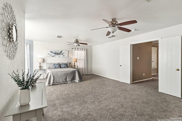 carpeted bedroom with ceiling fan and a textured ceiling