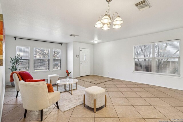 tiled living room featuring a chandelier