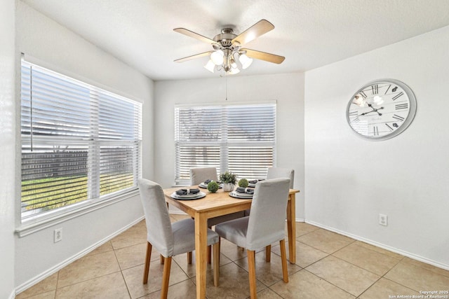 dining room featuring light tile patterned flooring, plenty of natural light, and ceiling fan