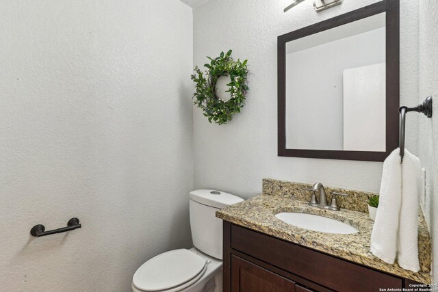 bathroom featuring toilet and vanity