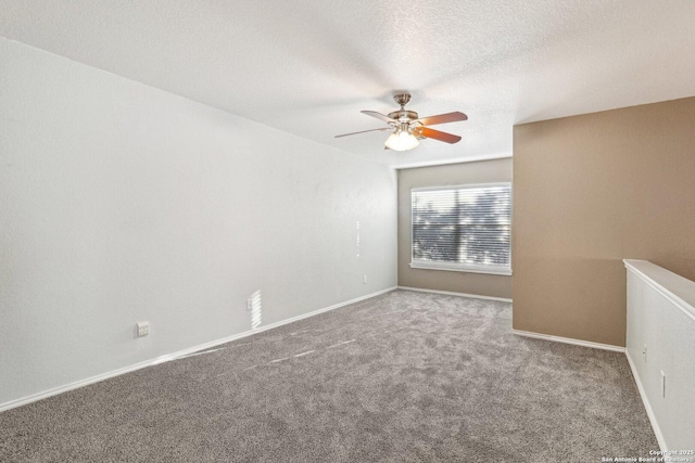 carpeted empty room with ceiling fan and a textured ceiling