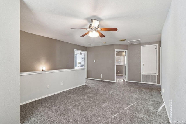 carpeted empty room with ceiling fan and a textured ceiling