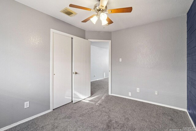 unfurnished bedroom with a closet, ceiling fan, and carpet