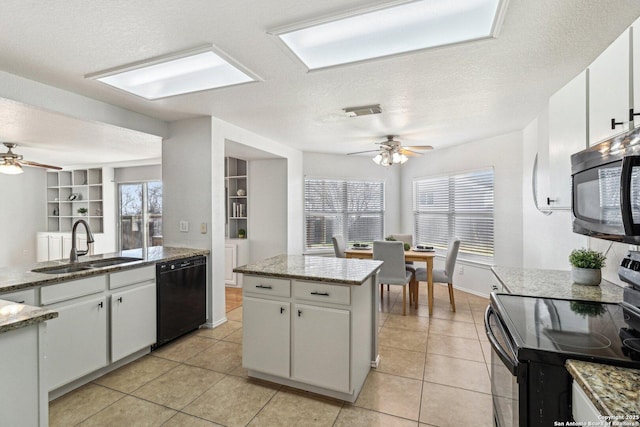 kitchen with black appliances, a textured ceiling, white cabinetry, sink, and built in features