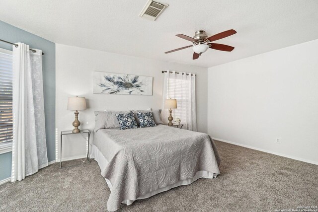 carpeted bedroom featuring a textured ceiling and ceiling fan