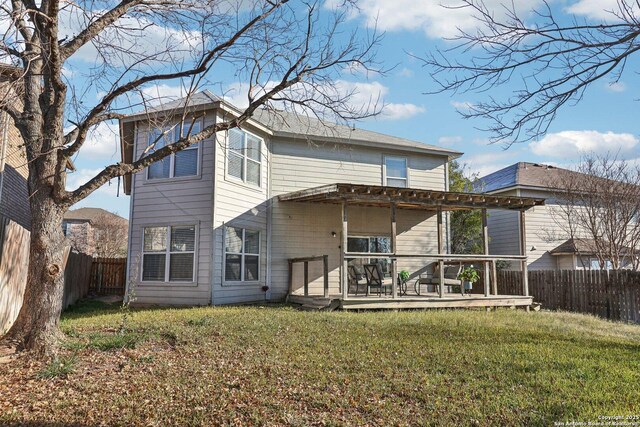 back of house with a deck and a yard