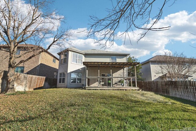 rear view of house featuring a yard