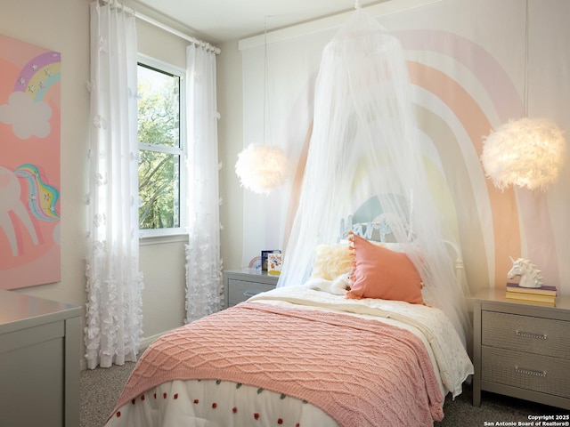 bedroom with carpet floors and multiple windows