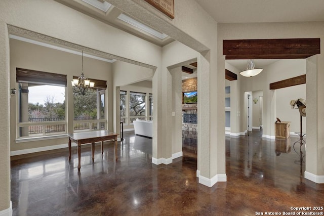 unfurnished dining area featuring a high ceiling and a notable chandelier