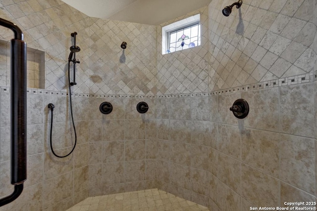 bathroom with tiled shower