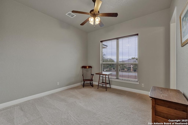 living area featuring light carpet and ceiling fan