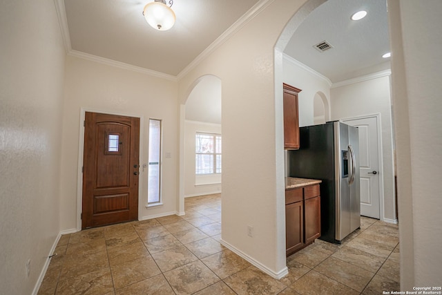 foyer entrance featuring ornamental molding