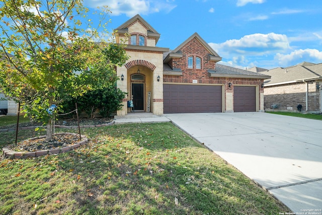 view of front of house featuring a garage and a front lawn