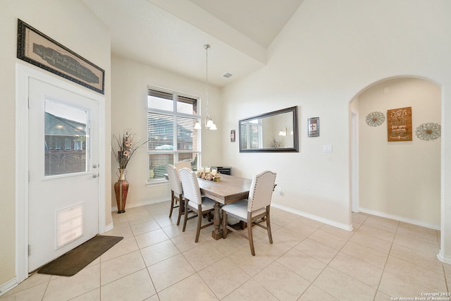 dining area featuring an inviting chandelier and light tile patterned floors