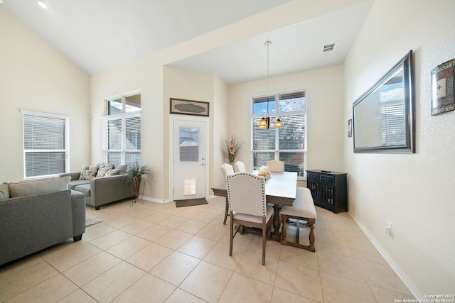 tiled dining area featuring lofted ceiling