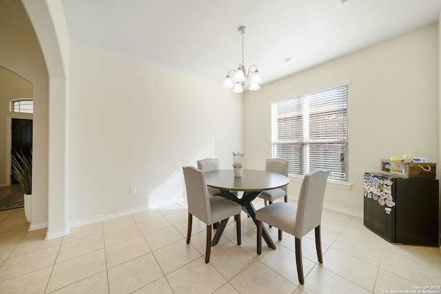 tiled dining area with an inviting chandelier